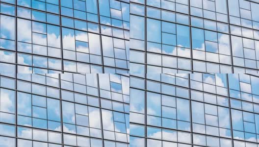 在蓝色的天空中有玻璃幕墙的现代蓝色建筑高清在线视频素材下载