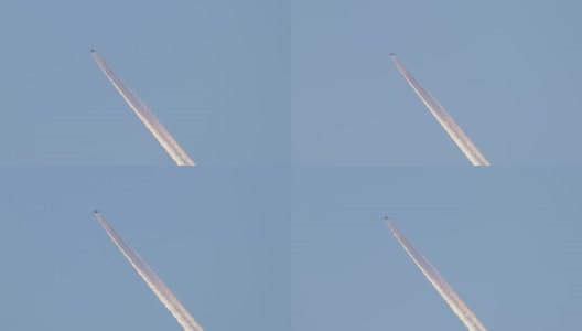远处的喷气式客机在晴朗的蓝天上高空飞行，留下白色的烟迹。航空运输的概念高清在线视频素材下载