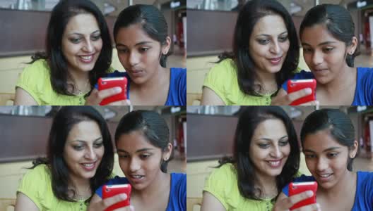 亚洲印度母亲和女儿使用手机阅读短信高清在线视频素材下载