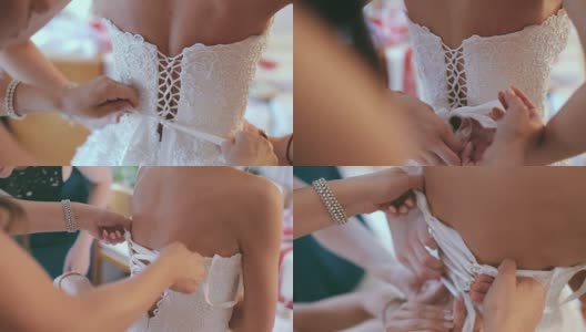 新娘正在打扮，由伴娘系她的礼服高清在线视频素材下载