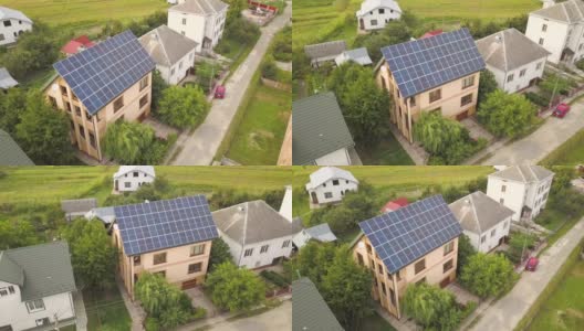 空中俯瞰新的现代住宅小屋与蓝色闪亮的太阳能光伏板系统的屋顶。可再生生态绿色能源生产理念。高清在线视频素材下载