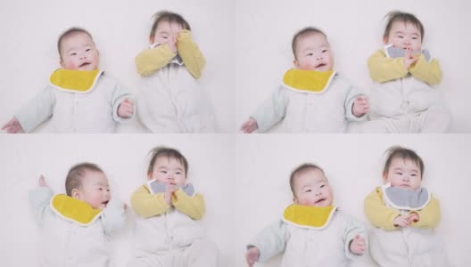 亚洲双胞胎婴儿睡觉时会笑高清在线视频素材下载