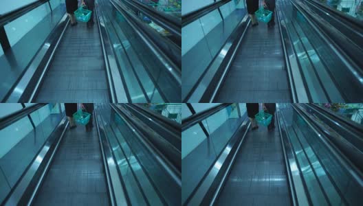 人们在购物中心的自动扶梯上走动高清在线视频素材下载