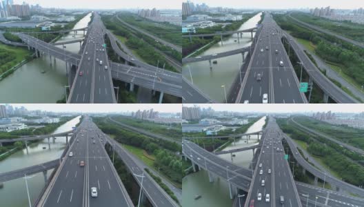 无人机的高速公路多层次交叉道路与移动的汽车在日落。汽车在多层路口行驶，是城市的概念。苏州城市,中国。高清在线视频素材下载