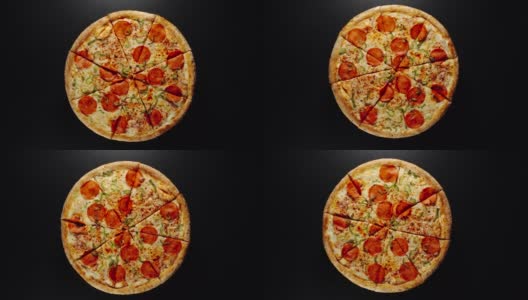 一个大披萨的圆圈在一个黑色的表面上旋转高清在线视频素材下载