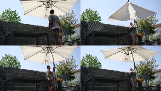 一个男人在阳台上撑开遮阳伞高清在线视频素材下载