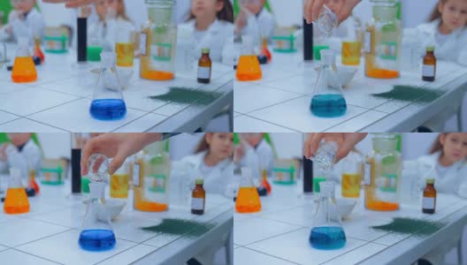 小学化学课-化学实验。孩子们在学校的实验室里学习化学高清在线视频素材下载