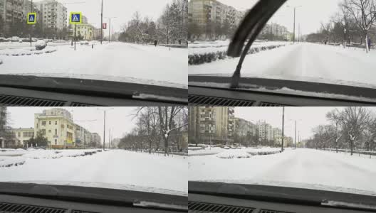 一场大雪过后，汽车载着雪行驶在城市道路上高清在线视频素材下载