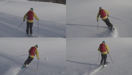 滑雪者在深粉中下山高清在线视频素材下载