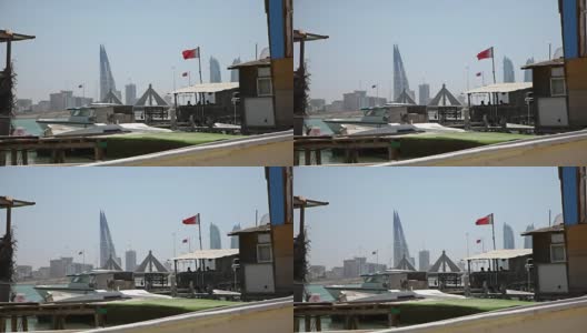巴林。渔船，旗帜和麦纳麦天际线高清在线视频素材下载