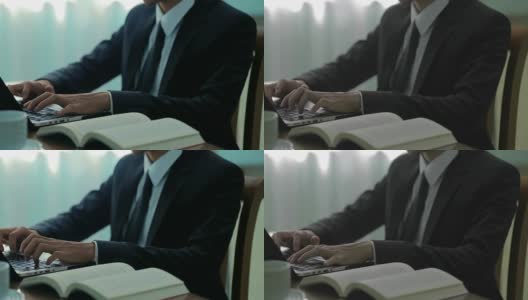 穿着西装的无名商人在办公室用笔记本努力工作，有两种色调高清在线视频素材下载