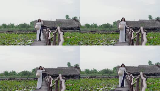 美丽的越南女人在大莲花湖的木桥上散步和呼吸新鲜空气的4k视频场景，越南，亚洲或东南亚的旅游概念高清在线视频素材下载