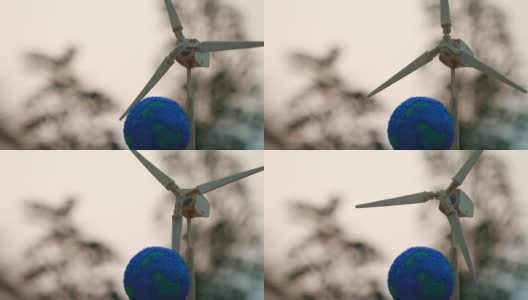 绿色能源/未来可替代能源或环境意识概念:风力涡轮机/风力磨坊与全球地球模型。可持续生态住宅理念家庭住宅，利用生态可再生高清在线视频素材下载