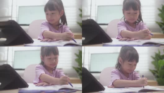 亚洲女儿在家里用数字平板电脑学习在线课程高清在线视频素材下载