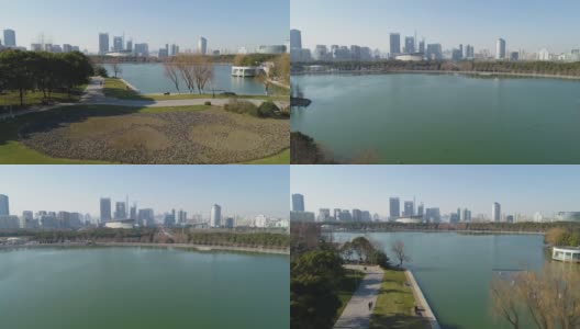 世纪公园和一个大湖在上海晴天。在市中心的背景。中国鸟瞰图。无人机是向前和向上飞行。远景高清在线视频素材下载