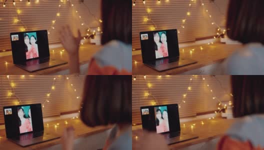 亚洲妇女用笔记本电脑在家里和朋友视频聊天高清在线视频素材下载