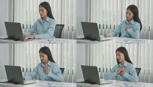 一名亚洲妇女在工作时感到胸部疼痛。高清在线视频素材下载