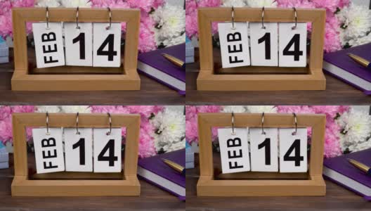 桌面日历与2月14日的日期和一束美丽的鲜花。精致的菊花情人节。手工木历，日期、月份和日期。为一天做计划。高清在线视频素材下载