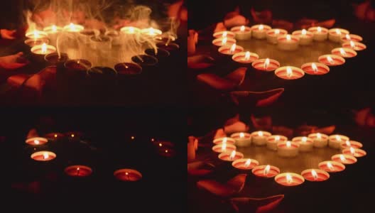 红色的心形蜡烛在黑暗中燃烧。高清在线视频素材下载