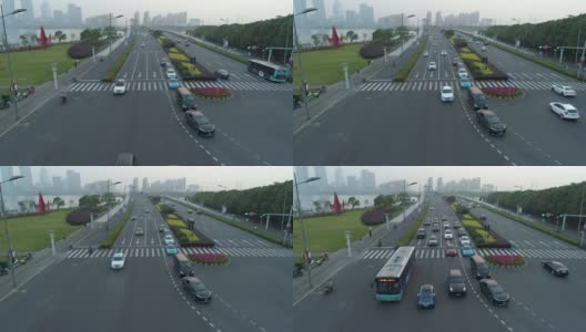 无人机拍摄的城市十字路口，汽车和公交车行驶在大道上。在日落时高清在线视频素材下载