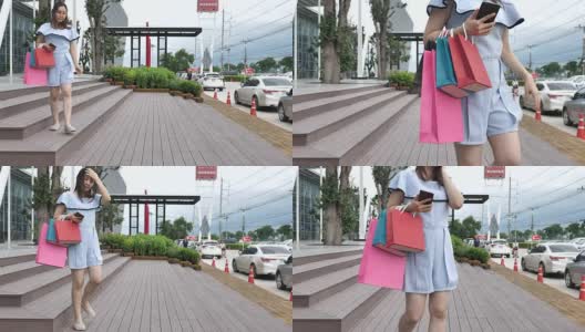 拎着购物袋在购物中心散步的女人高清在线视频素材下载