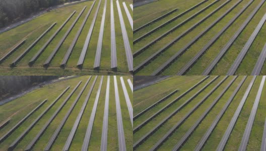 太阳能电池板发电的鸟瞰图。一排排的太阳能电池板安装在农田、草地或农村地区。生态和可再生绿色能源的概念。前拍摄高清在线视频素材下载