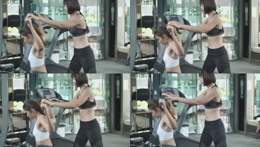 亚洲女人在健身房健身教练，慢动作高清在线视频素材下载