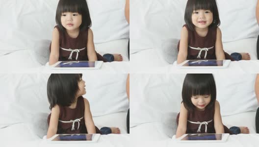 亚洲宝宝在家里和妈妈一起使用平板电脑高清在线视频素材下载