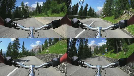 HD骑着自行车沿着一条高山路下山高清在线视频素材下载