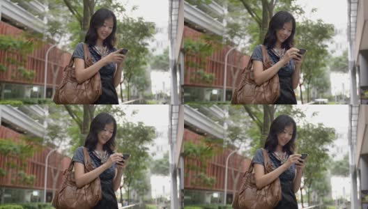 迷人的亚洲女商人用手机发短信高清在线视频素材下载