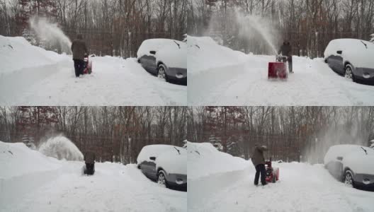 在一场冬季暴风雪后，一名男子正在清理他的汽车周围被雪覆盖的车道。启动snow-thrower。高清在线视频素材下载