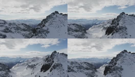 在法国的库尔舍维尔，雪山映衬着多云的天空，无人驾驶飞机在多云的日子里拍摄到令人惊叹的阿尔卑斯山脉被雪覆盖的山脊高清在线视频素材下载