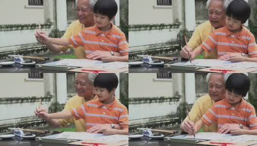 书法祖父和孙子写作高清在线视频素材下载