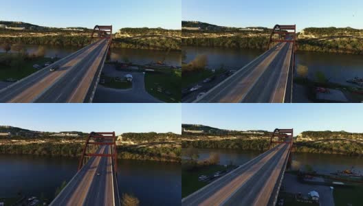 倾斜的深视角Pennybacker桥或360桥或首府德克萨斯高速公路桥在科罗拉多河或城镇湖的日落时间空中日落黄金小时从360桥罕见的一边倾斜高清在线视频素材下载