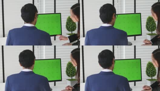 4K:两个亚洲人在电脑绿屏上谈生意高清在线视频素材下载