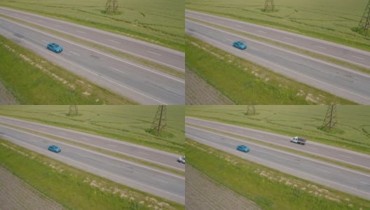 漂亮的蓝色汽车在高速公路上行驶。豪华电动汽车在绿色田野的背景下行驶。缓慢的运动。鸟瞰图。高清在线视频素材下载