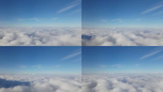 从飞机窗口俯瞰蓝天云层，这是令人惊叹的鸟瞰图。拍摄分辨率为4k高清在线视频素材下载