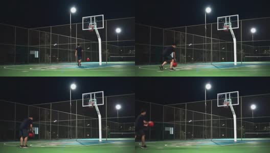 运动概念:一个人晚上独自在室外打篮球。高清在线视频素材下载
