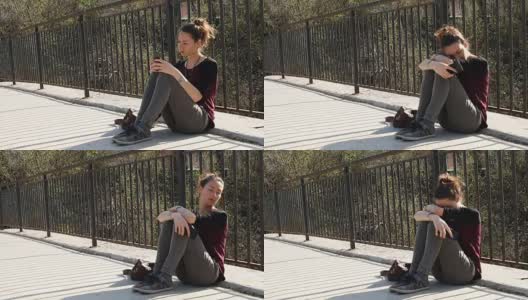 悲伤的女孩坐在桥上高清在线视频素材下载