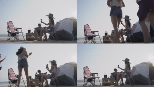 一群亚洲朋友在海滩上野营度假。高清在线视频素材下载