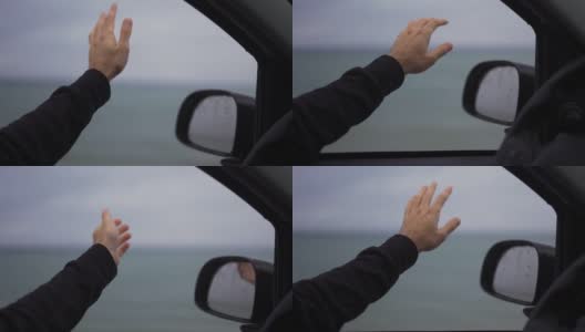 一个男人在雨天开车时，手正在接雨高清在线视频素材下载