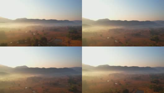 无人机俯瞰农田上雾蒙蒙的景象。4 k高清在线视频素材下载