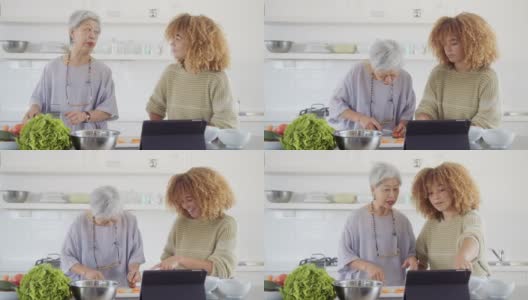 活跃的老年妇女和孙女一起做健康的饭菜高清在线视频素材下载