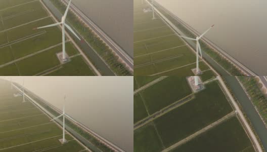 在海边附近的环保可再生风车站上空飞行。大型白色涡轮机产生可替代的安全风能。高清在线视频素材下载
