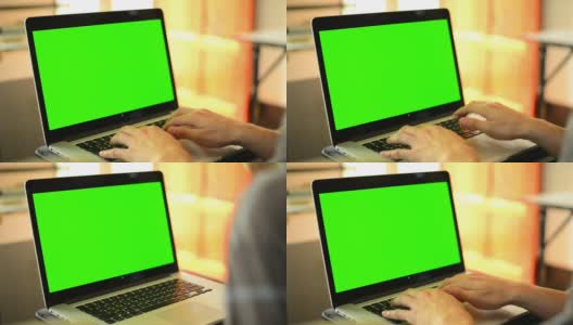 在绿色屏幕的笔记本电脑上打字高清在线视频素材下载