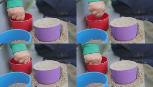 小手认不出来的小男孩小男孩正在玩砂子塑料模具的特写高清在线视频素材下载