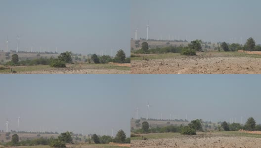 多利在风力发电场拍摄风力发电的风车高清在线视频素材下载