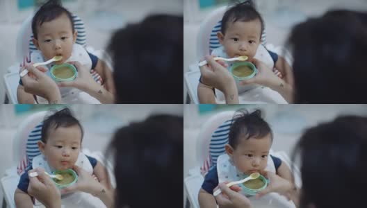 可爱的婴儿吃婴儿食品高清在线视频素材下载