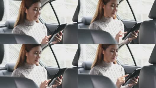 女性在汽车的副驾驶座上使用智能手机高清在线视频素材下载