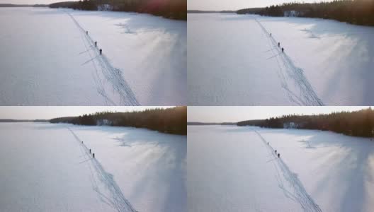 芬兰，四个人在厚厚的雪地上滑雪高清在线视频素材下载